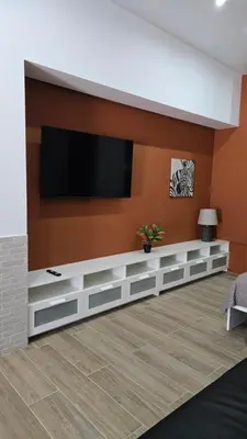 a living room with a television on a wall at Apartamentos Vicent Clavel in Valencia