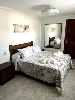 a bedroom with a bed and a large mirror at Casa el Catorce 18 in Bolbaite
