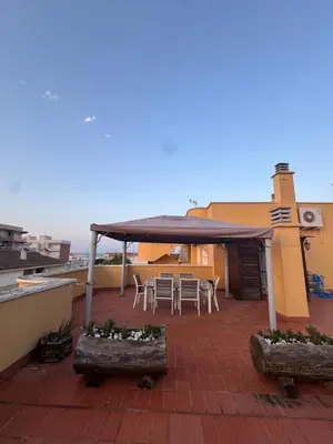 a patio with a table and chairs on a roof at Gaviota Azul, Perelló in Sueca