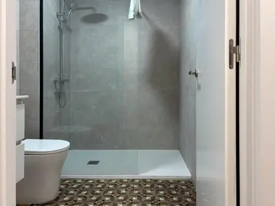 a bathroom with a shower with a toilet and a glass door at Quart Historic Stay 2 in Valencia