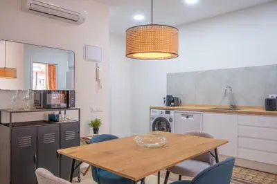 a kitchen and dining room with a wooden table and chairs at Quart Historic Stay 2 in Valencia