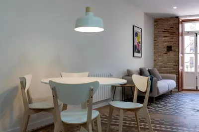 a living room with a table and chairs and a couch at Quart Historic Stay 2 in Valencia
