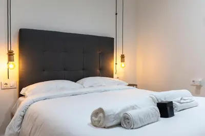 a bedroom with a large bed with towels on it at Quart Historic Stay 2 in Valencia
