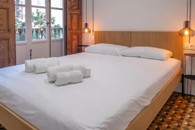 a bedroom with a large white bed with towels on it at Quart Historic Stay 2 in Valencia