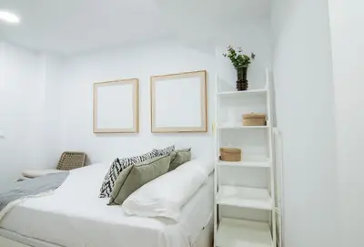 a bedroom with white walls and a bed with white shelves at Casa Sant Domènec Savio in Valencia