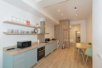 a kitchen with a counter with a microwave and a table at GuestReady - Charming place in Valencia in Valencia