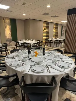a dining room with tables with plates and wine glasses at Hotel Turia Valencia in Valencia