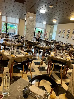 a dining room with tables and chairs with glasses on them at Hotel Turia Valencia in Valencia