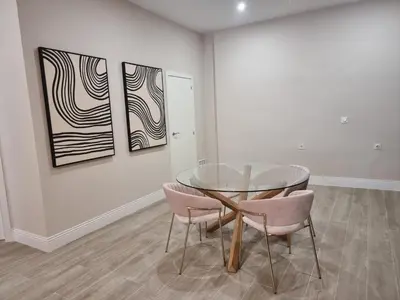 a dining room with a glass table and two chairs at MD Senda del Aire in Valencia