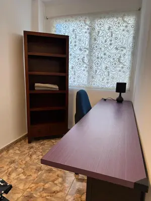 an office with a desk and a book shelf at Sweet Stay Valencia in Valencia