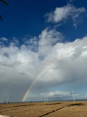 a rainbow in the sky over a beach at Sweet Stay Valencia in Valencia