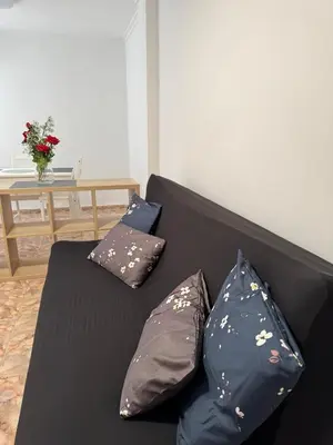a black couch with three pillows on it at Sweet Stay Valencia in Valencia
