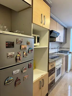a kitchen with a refrigerator with magnets on it at Sweet Stay Valencia in Valencia