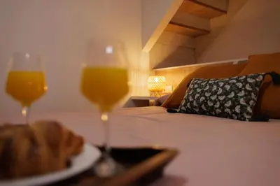 a table with a plate of food and two glasses of orange juice at Urban apartment BAJO 6 - HOUSEVANLIVE in Valencia