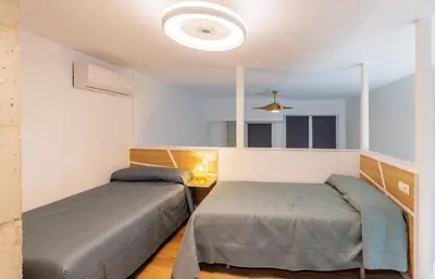 a bedroom with two beds and a mirror at Urban apartment BAJO 6 - HOUSEVANLIVE in Valencia