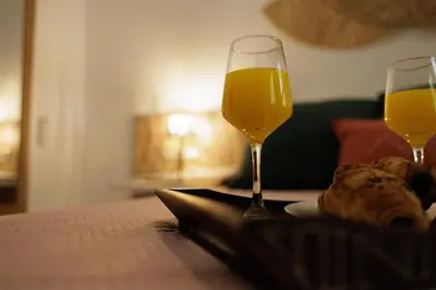 a table with two glasses of orange juice and bread at Urban apartment BAJO 8 - HOUSEVANLIVE in Valencia