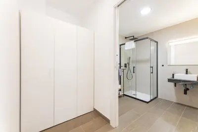 a bathroom with a shower and a sink at Suite Deluxe Valencia - Beach II Apartments in Valencia