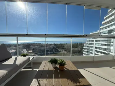 a living room with a couch and a table at Gran Canet Salva, moderno apartamento con terraza y vistas al mar in Canet de Berenguer