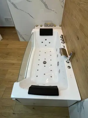 a white bath tub sitting on top of a floor at Loft con jacuzzi y piscina in Valencia