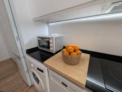 a bowl of oranges on a counter in a kitchen at Apartamento Tucán in Valencia
