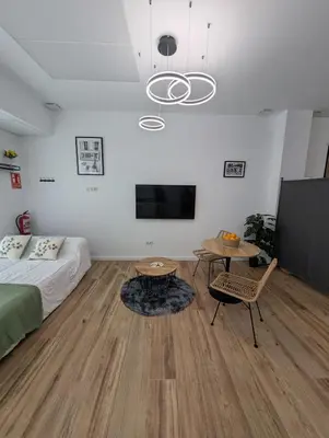 a bedroom with a bed and a table and a tv at Apartamento Tucán in Valencia