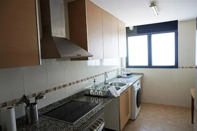 a bedroom with a large bed with wooden cabinets at PinyaLabs Sunrise Valencia, mer & montagne à 10min in Puebla de Farnals