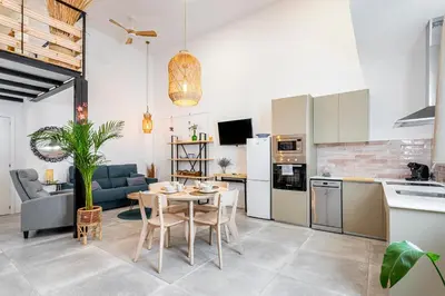 a kitchen and living room with a table and chairs at Lovely duplex on the beach in Valencia