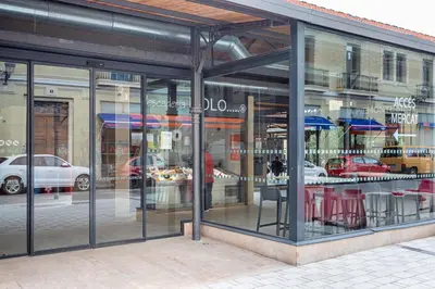 a store front with glass windows on a street at Lovely duplex on the beach in Valencia