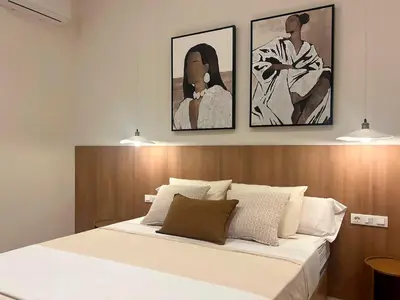 a bedroom with a bed with two pictures on the wall at Pivote Flats-Puerto C in Valencia