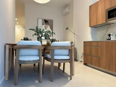 a dining room with a table and two chairs at Pivote Flats-Puerto C in Valencia