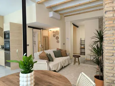 a living room with a white couch and a table at Apartment next to the Marina De Valencia in Valencia