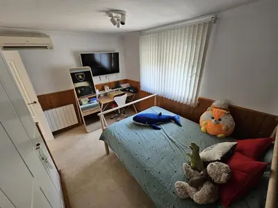 a bedroom with stuffed animals sitting on a bed at Amazing Villa with swimming pool in El Vedat de Torrente in Torrent