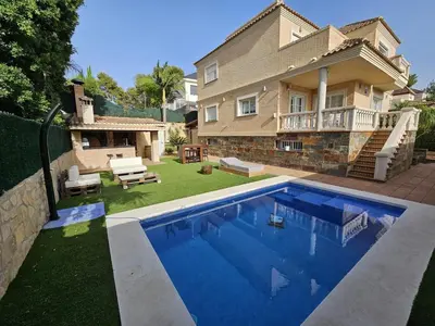 a house with a swimming pool in front of a house at Amazing Villa with swimming pool in El Vedat de Torrente in Torrent