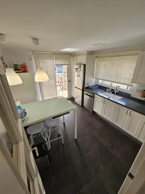 a kitchen with a table and a counter top at Amazing Villa with swimming pool in El Vedat de Torrente in Torrent