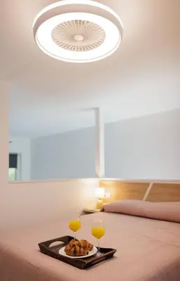 a bed with a plate of food and two glasses of wine at Urban apartment 4 BAJO - Housevanlive in Valencia