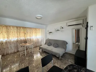 a living room with a couch and a table at Apartamento edificio JUMAR in Cullera