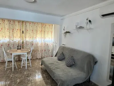 a living room with a couch and a table at Apartamento edificio JUMAR in Cullera