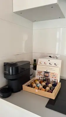a box of donuts sitting next to a coffee maker at Duplex Miguelete tower & 4th FLOOR and NO elevator in Valencia