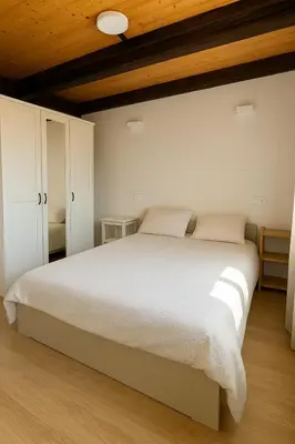 a bedroom with a large bed and white cabinets at Duplex Miguelete tower & 4th FLOOR and NO elevator in Valencia