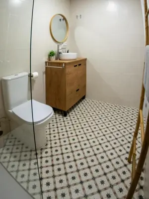a bathroom with a toilet and a sink and a mirror at Boho Beach Flats in Valencia