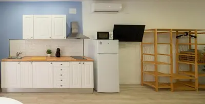a kitchen with a white refrigerator and a shelf at Boho Beach Flats in Valencia