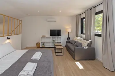 a bedroom with a bed and a couch and a tv at GuestReady - Beautiful loft in Valencia in Valencia