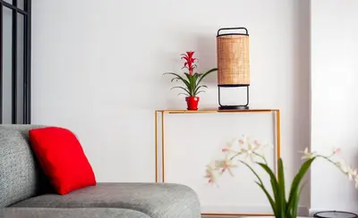 a living room with a couch and a red pillow at La Casa del Mar-Cabañal 3BR Suites in Valencia