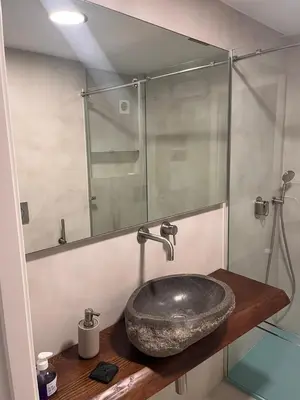 a bathroom with a sink and a glass shower at Tranquil Coastal Living in Puebla de Farnals