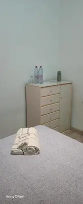 a bedroom with a bed and a dresser with a telephone at Relax y bienestar in Valencia