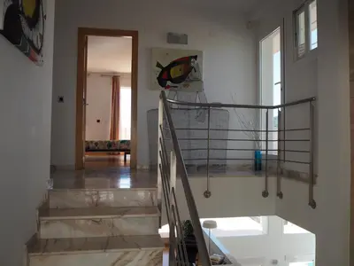a staircase with a metal railing in a room at Brisas de Sierra Calderona in Gilet