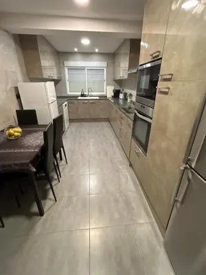 a large kitchen with a table and a refrigerator at Chalet encanto in Chiva