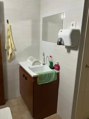 a bathroom with a sink and a mirror at Habitaciones Espacio in Corbera de Alcira