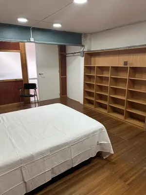 a bedroom with a white bed and shelves at Habitaciones Espacio in Corbera de Alcira