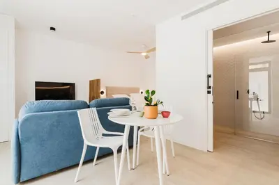 a living room with a blue couch and a table at Fantástico loft en Valencia in Valencia